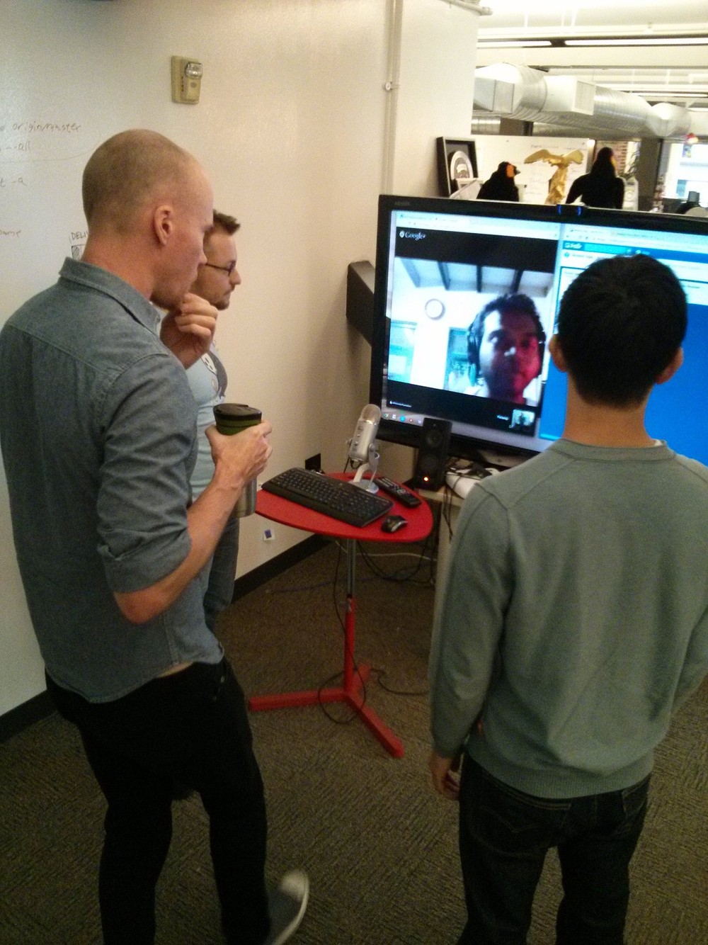 Software developers in a mobile apps team stand-up meeting